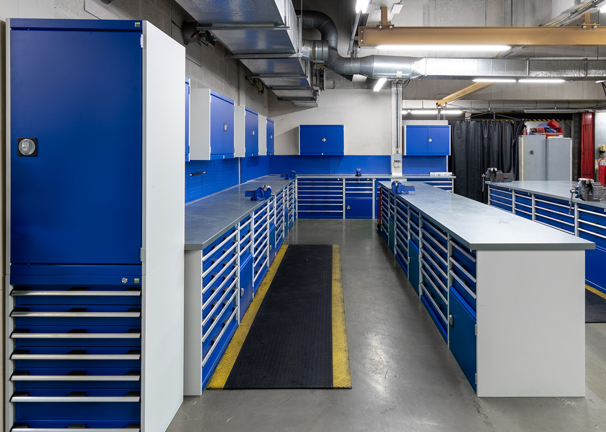 Blue warehouse storage solution with steel clad worktops.