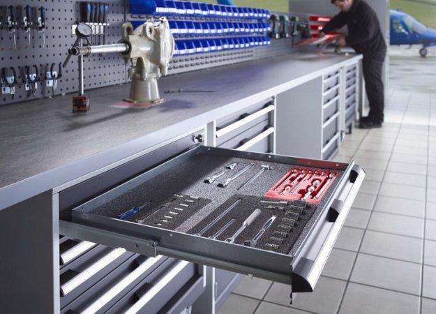 Warehouse storage solution with lino worktop in grey.