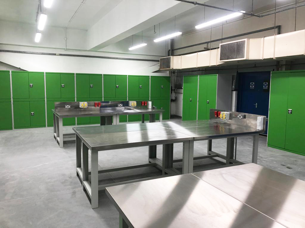 Three workplace benches with stainless steel clad worktops.